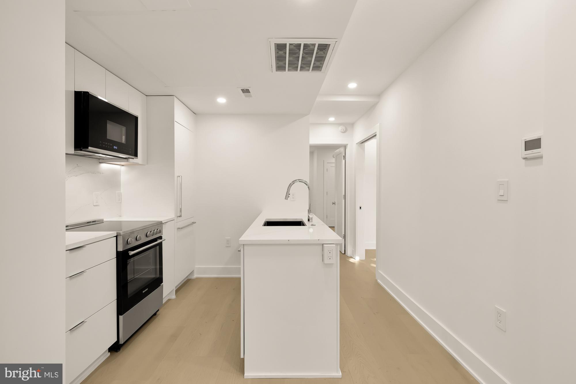 2116 Kalorama Road Northwest, Unit 104 Washington, DC 20008 - Photo 15 of 33 a kitchen with a stove and a microwave