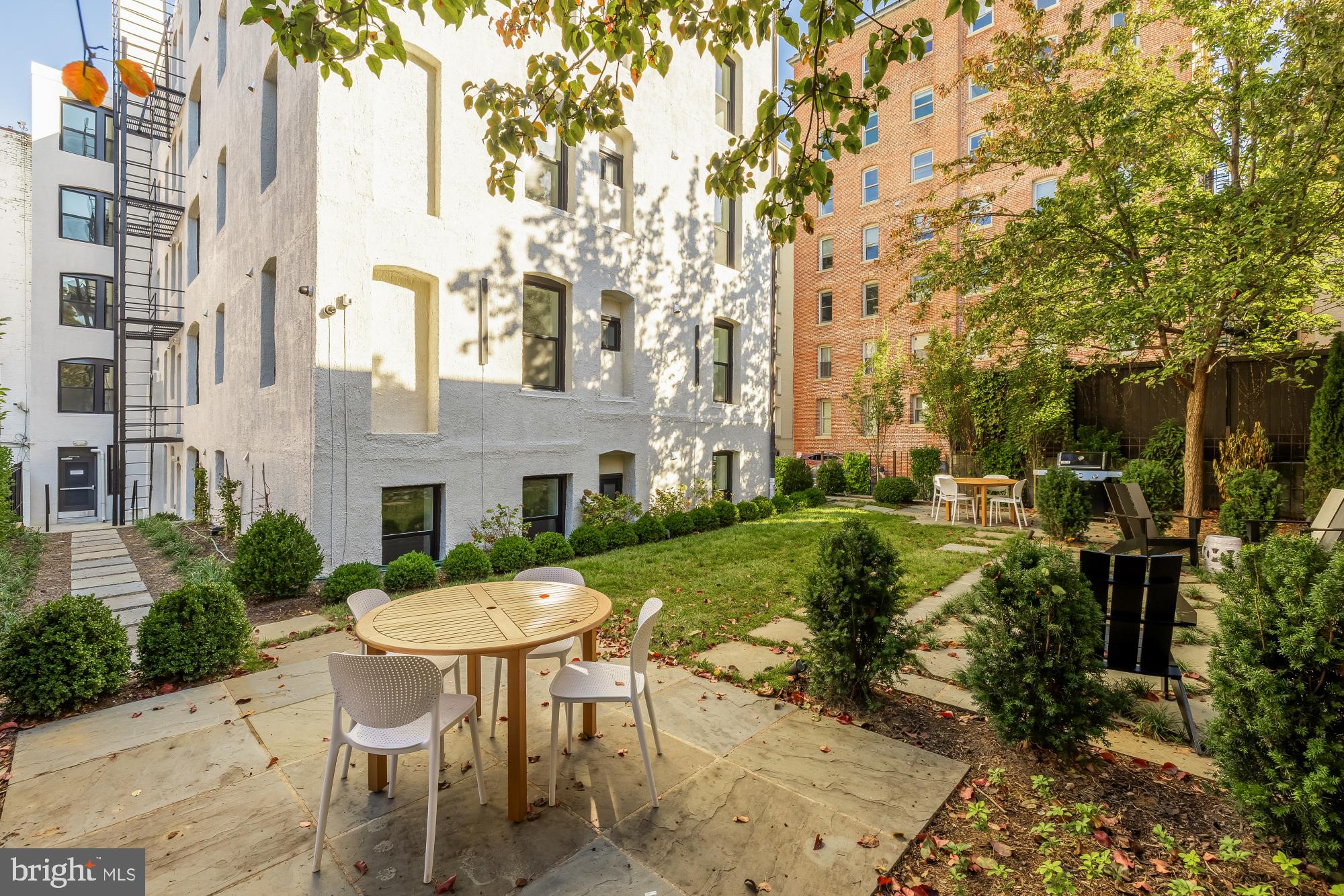 2116 Kalorama Road Northwest, Unit 104 Washington, DC 20008 - Photo 30 of 33 a view of a patio with a table and chairs under an umbrella