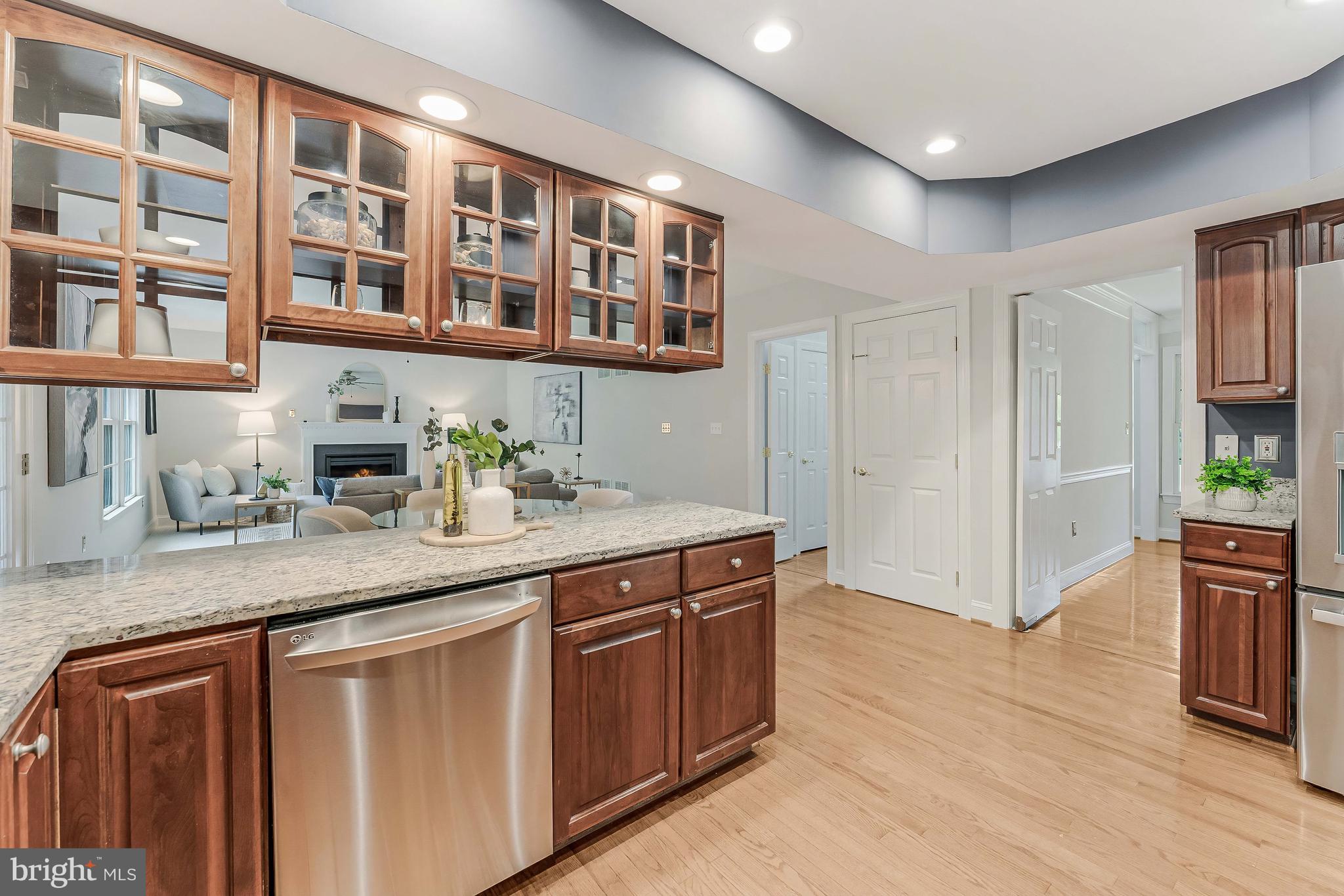 8926 Jameson Street Lorton, VA 22079 - Photo 13 of 32 a kitchen with stainless steel appliances granite countertop a sink stove and cabinets