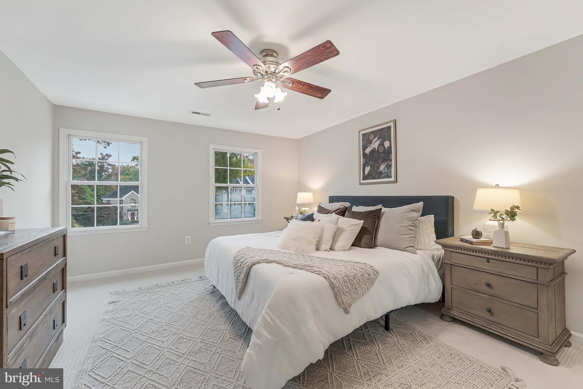 8926 Jameson Street Lorton, VA 22079 - Photo 16 of 32 a bedroom with a large bed and a window