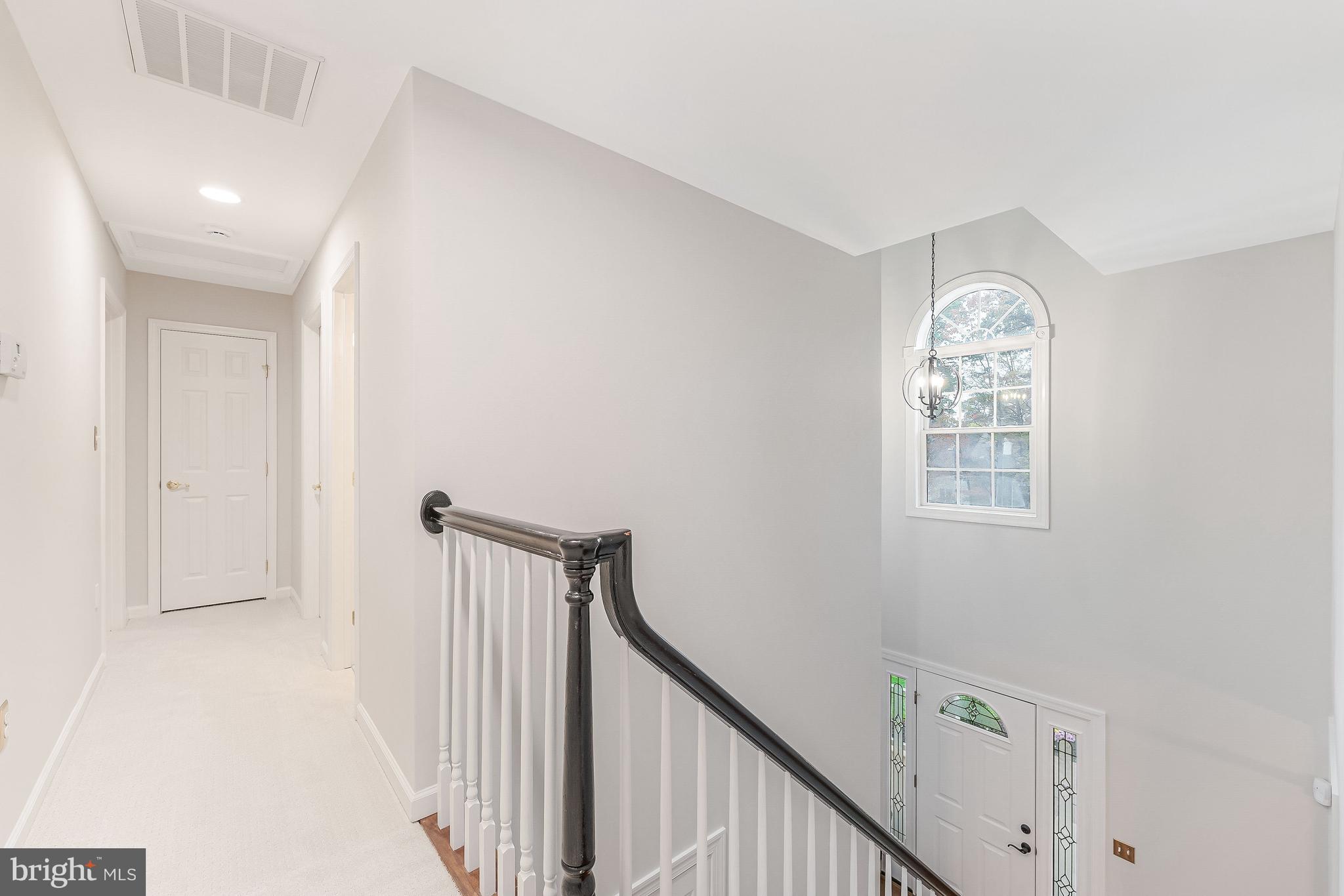 8926 Jameson Street Lorton, VA 22079 - Photo 21 of 32 a view of a hallway with windows