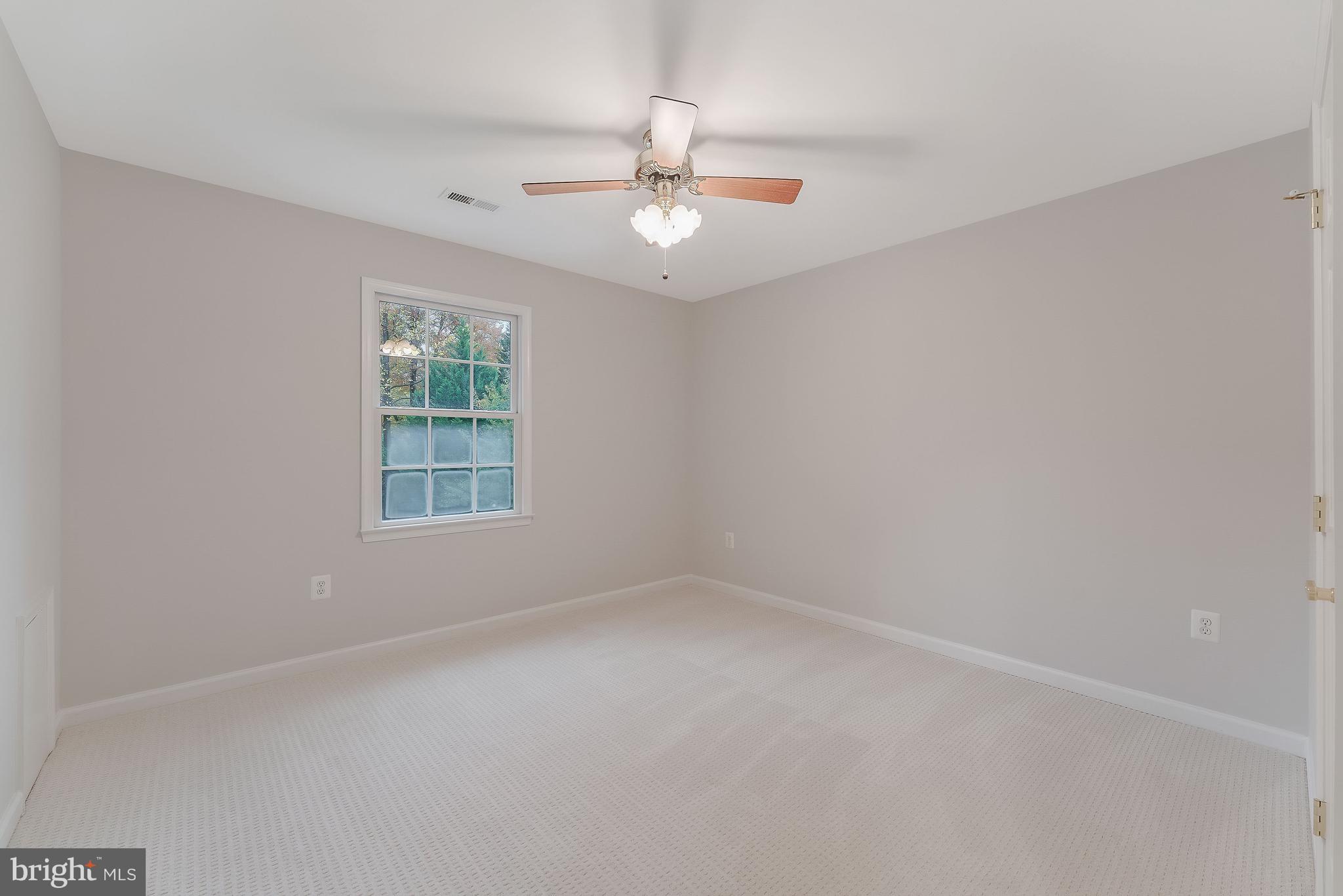 8926 Jameson Street Lorton, VA 22079 - Photo 22 of 32 an empty room with a window and a fan