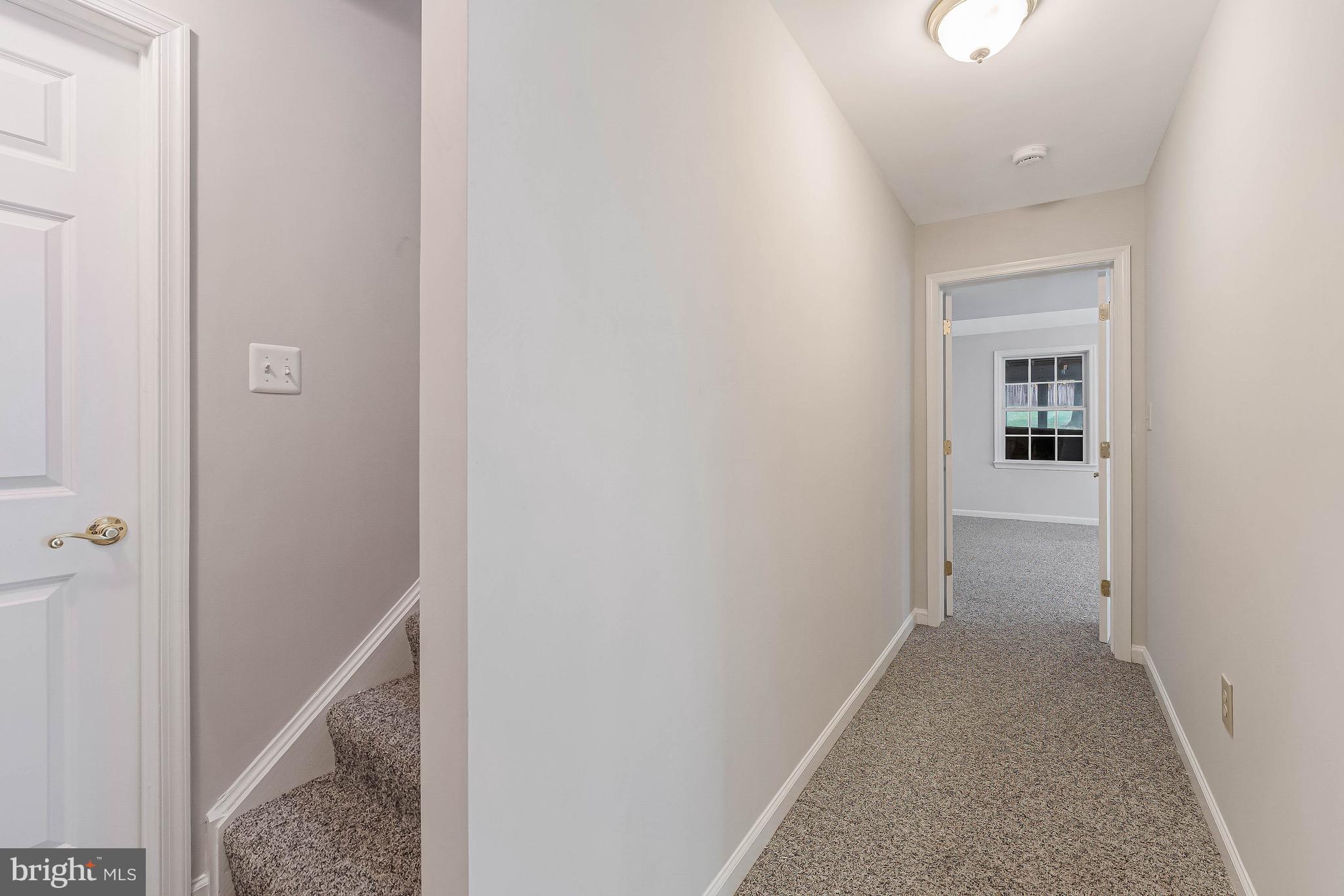 8926 Jameson Street Lorton, VA 22079 - Photo 26 of 32 a view of a hallway with a white walls and a white door