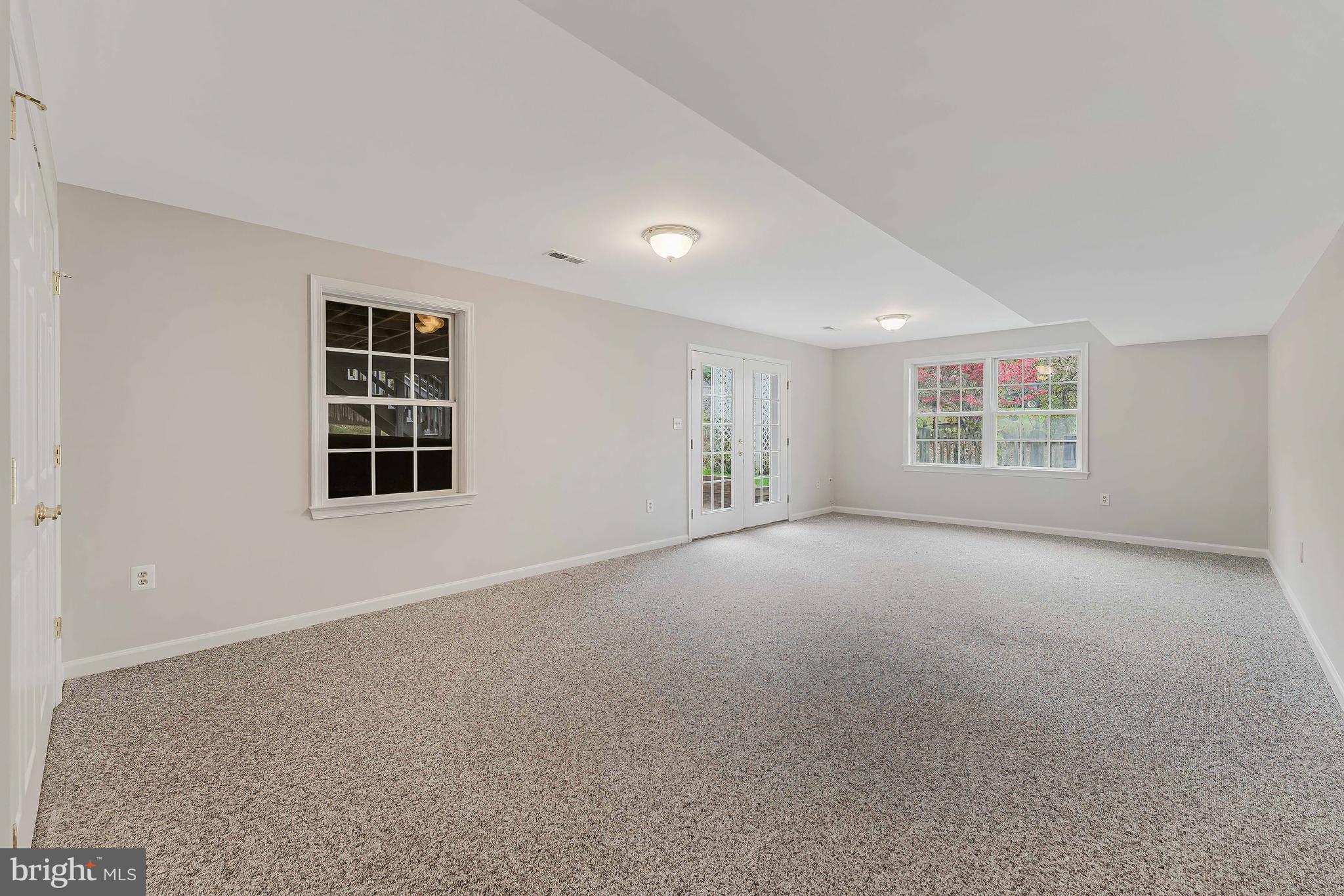 8926 Jameson Street Lorton, VA 22079 - Photo 27 of 32 a view of a big room with windows and chandelier fan