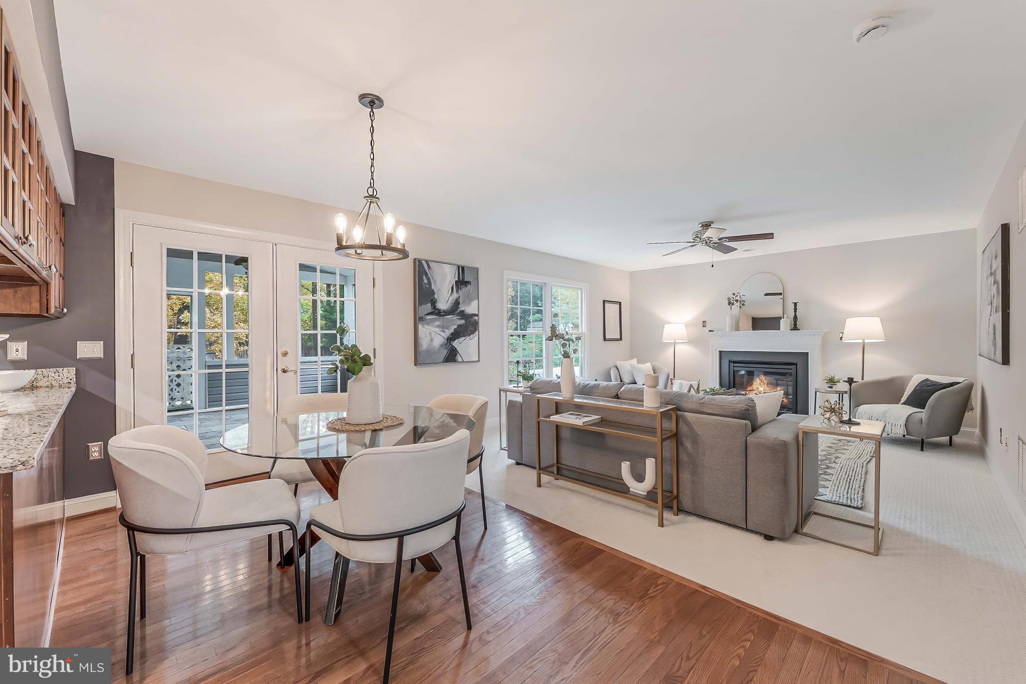 8926 Jameson Street Lorton, VA 22079 - Photo 5 of 32 a living room with furniture a fireplace and a chandelier