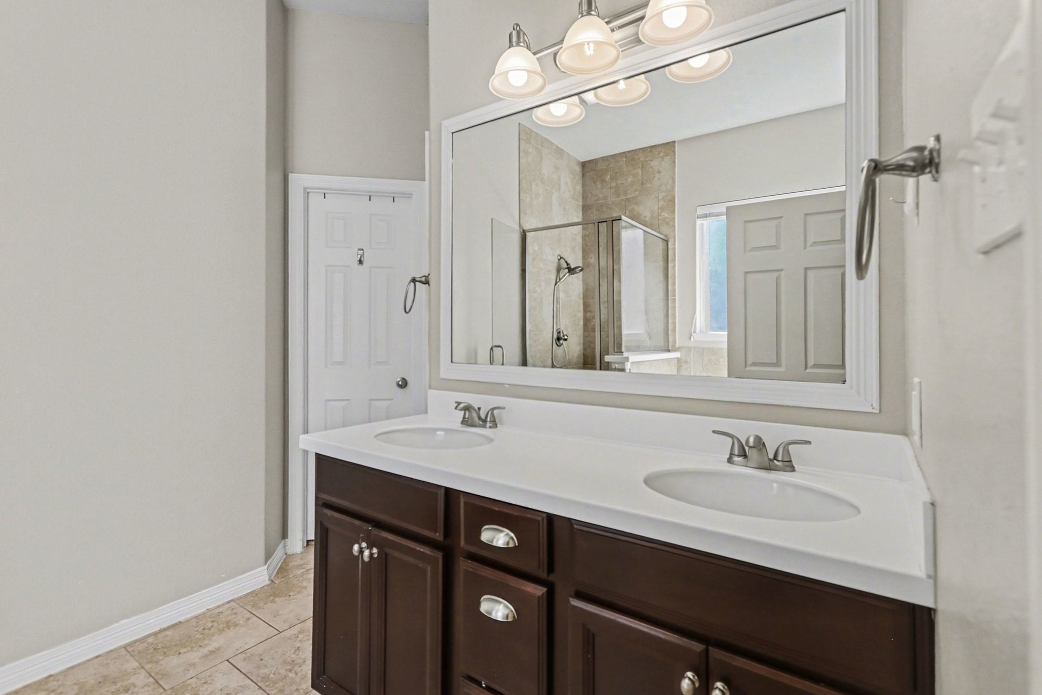 27006 Cliff Pointe Lane Katy, TX 77494 - Photo 22 of 34 Spacious primary bath featuring a dual-sink vanity, expansive mirror, and clean, neutral finishes designed for easy mornings and shared space.