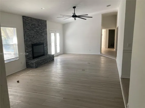 a view of a livingroom with wooden floor a fireplace