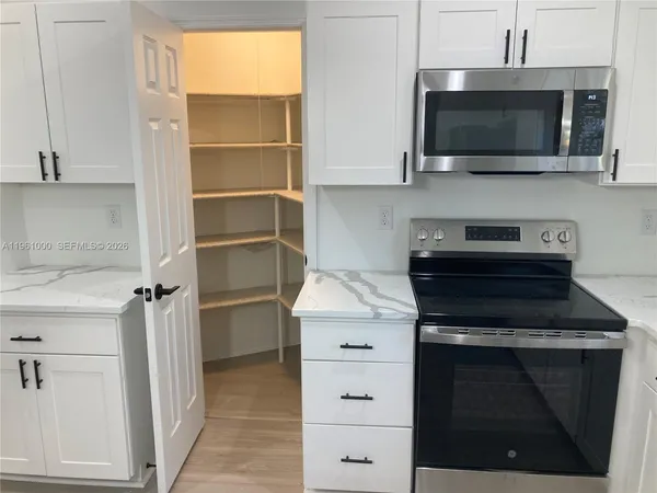 a kitchen with a stove and a microwave