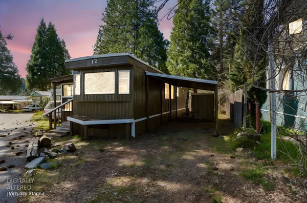a backyard of a house with a yard and outdoor seating