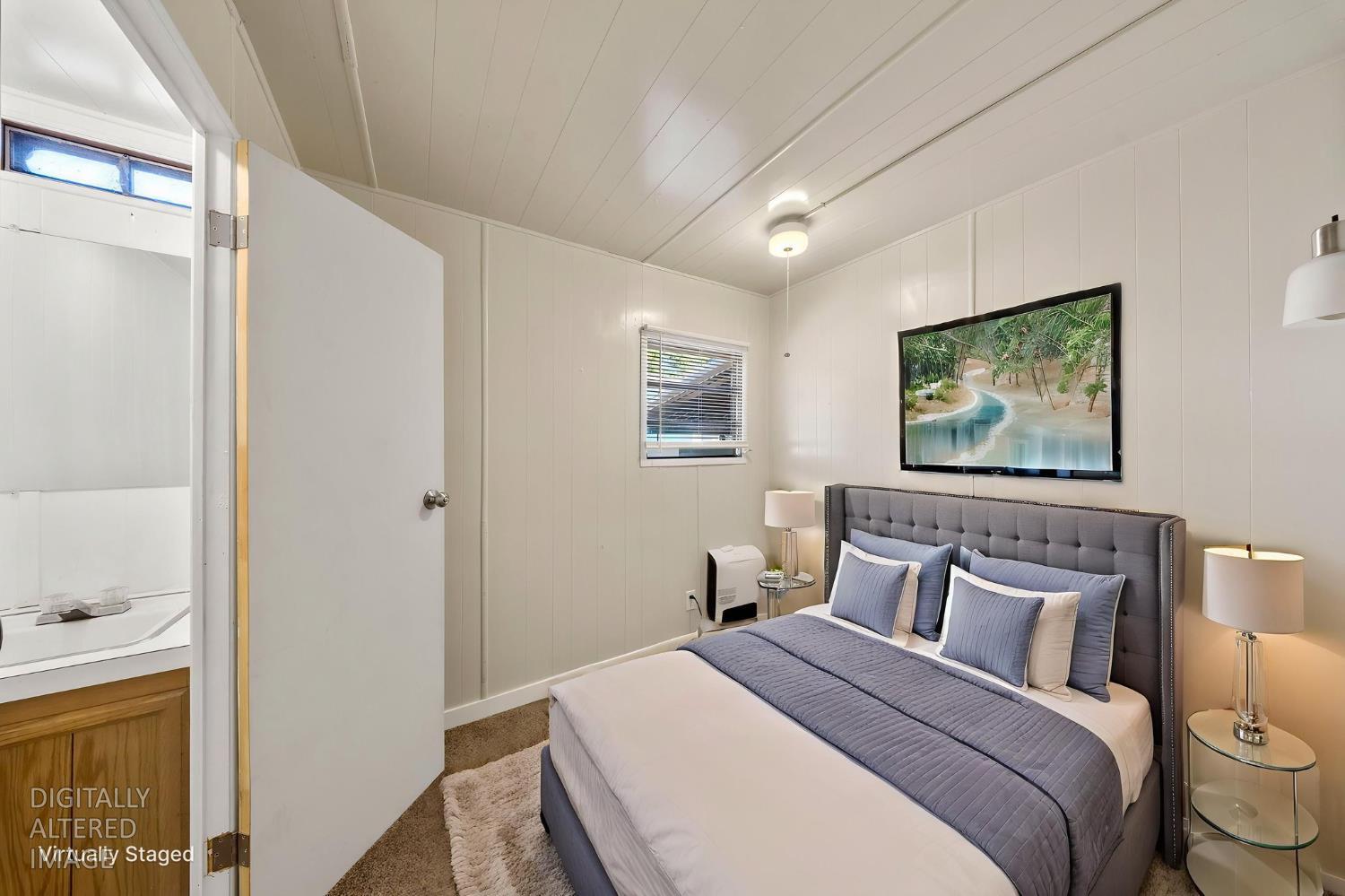 4482 Moran Road, Unit 12 Avery, CA 95224 - Photo 15 of 21 a bedroom with a bed and a painting on the wall