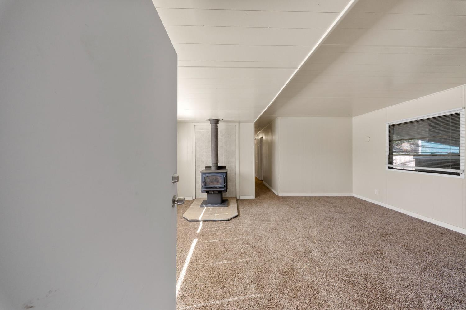 4482 Moran Road, Unit 12 Avery, CA 95224 - Photo 8 of 21 an empty room with chandelier fan and windows