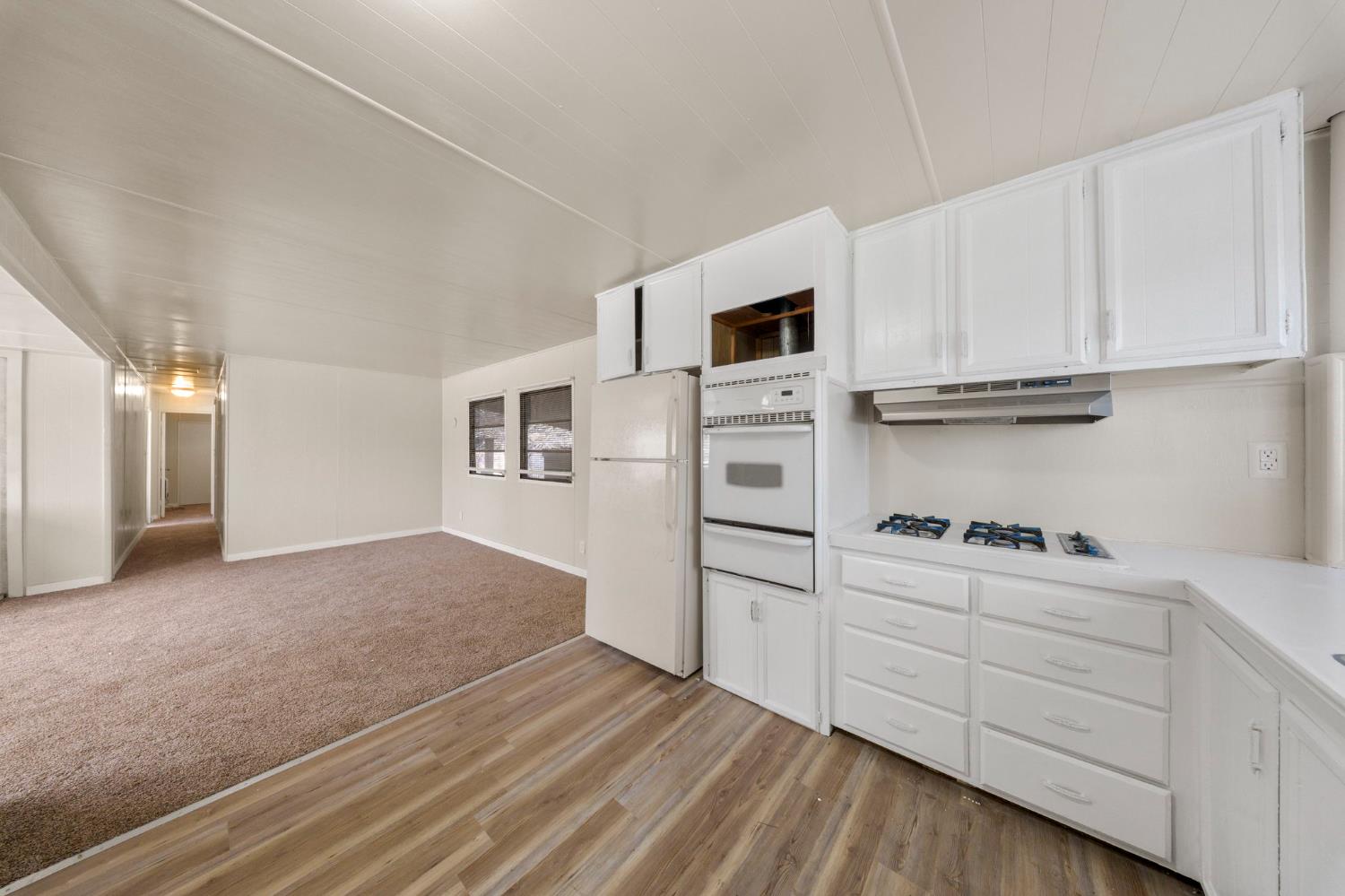 4482 Moran Road, Unit 12 Avery, CA 95224 - Photo 9 of 21 a kitchen with white cabinets and appliances