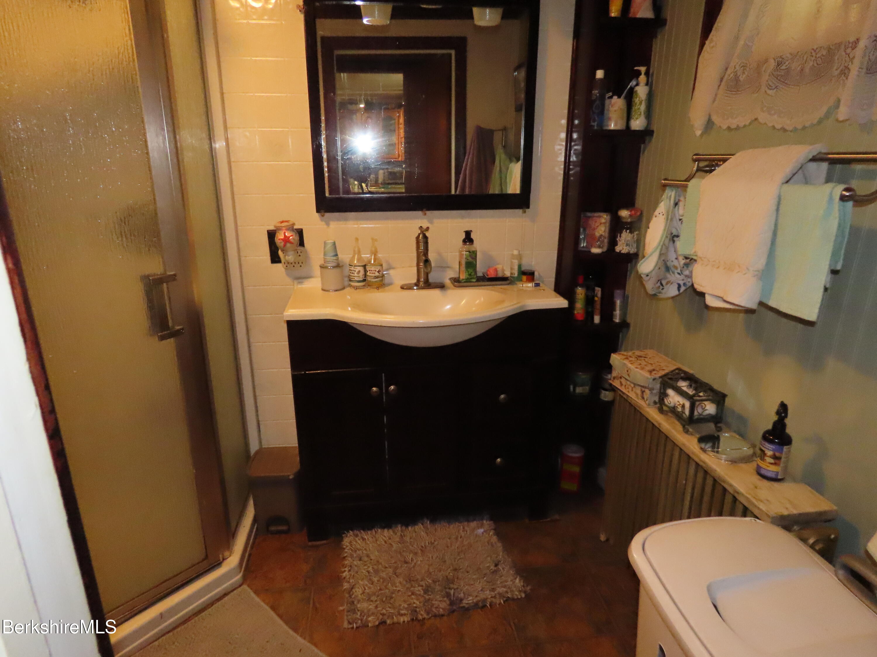 1138 Main Road Stamford, VT 05352 - Photo 22 of 46 a bathroom with a sink vanity mirror and toilet