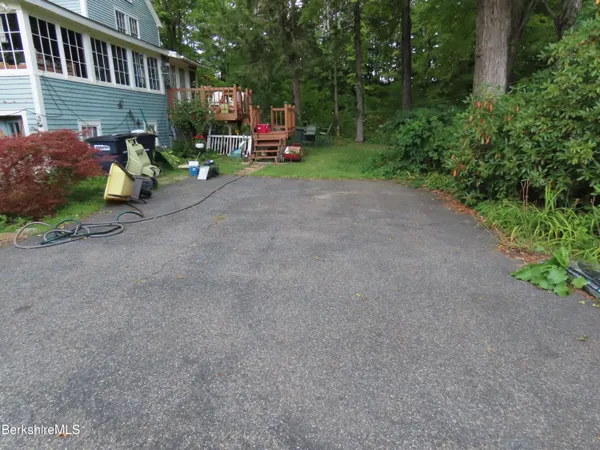 a front view of a house with a yard and trees