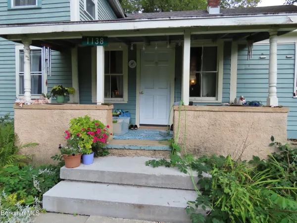 a view of a house with a yard covered in snow