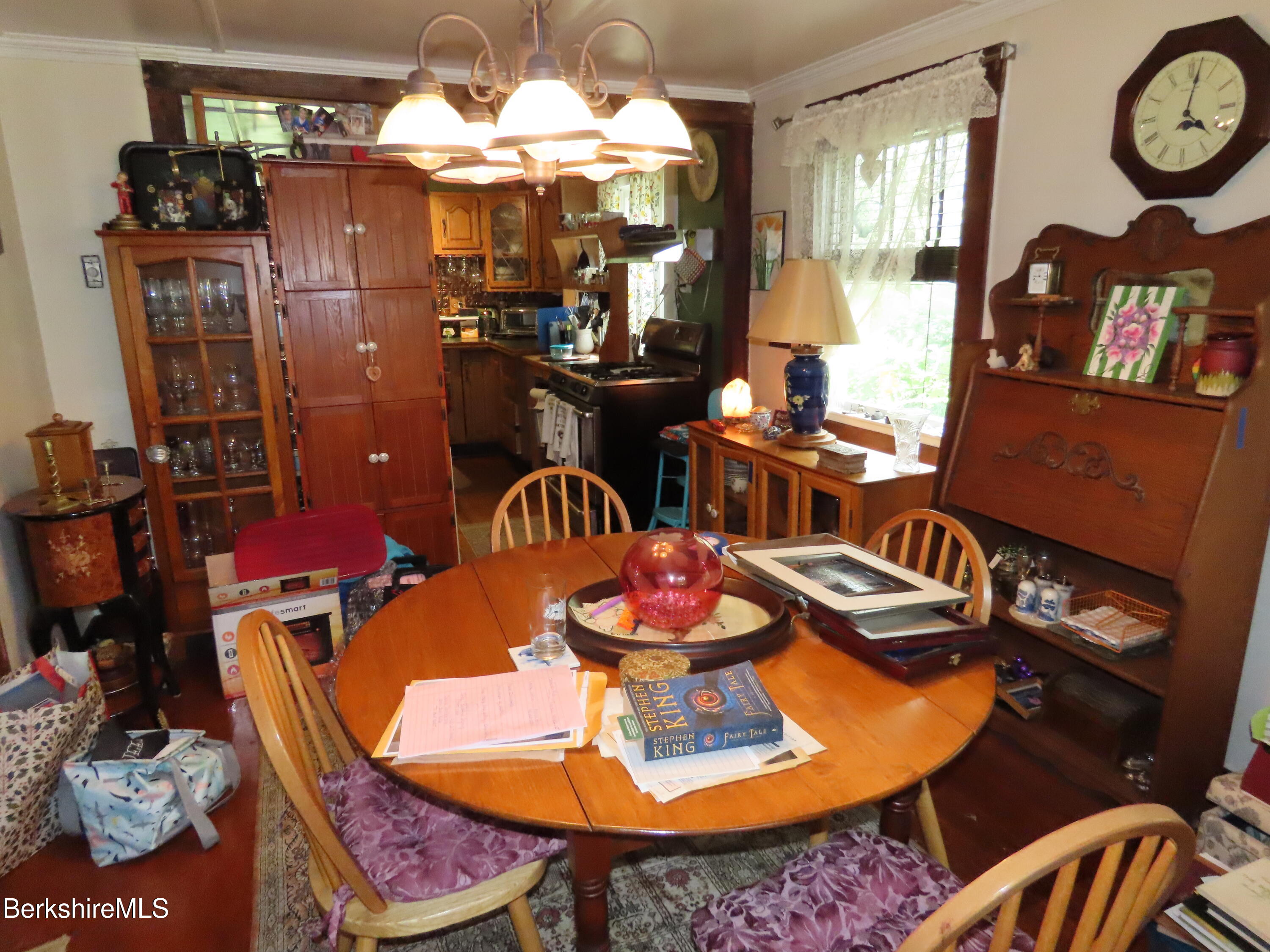 1138 Main Road Stamford, VT 05352 - Photo 8 of 46 a dining room with furniture a kitchen view and a chandelier