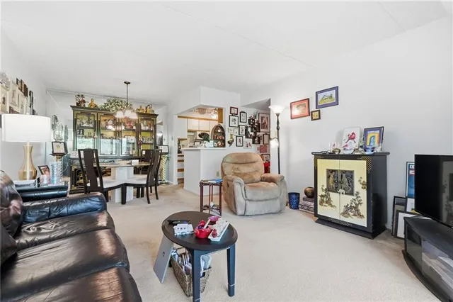 a view of a dining room with furniture and a chandelier