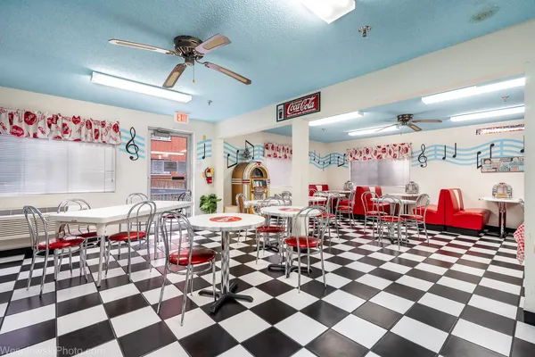 a group of people sitting in a room with black white walls