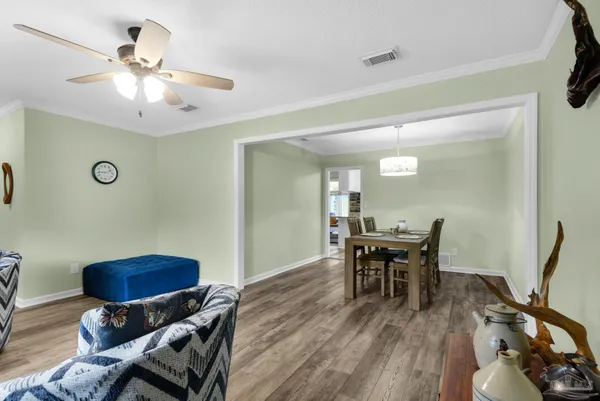 a dining room with furniture and wooden floor