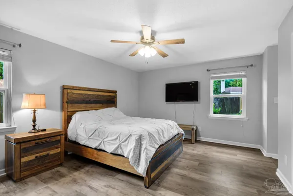 a bedroom with a bed and a flat screen tv