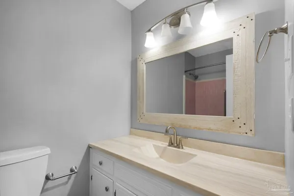a bathroom with a sink toilet and mirror