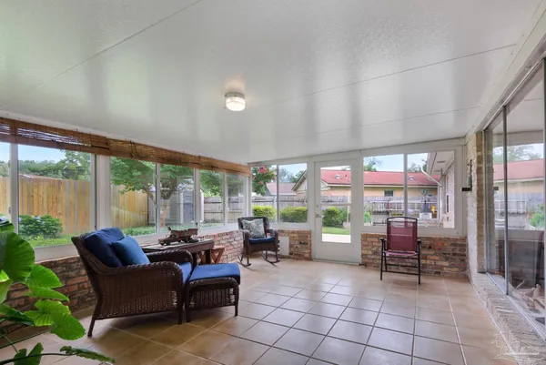 a living room with furniture and large windows