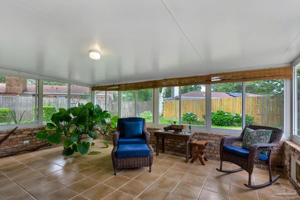 a living room with furniture and a floor to ceiling window