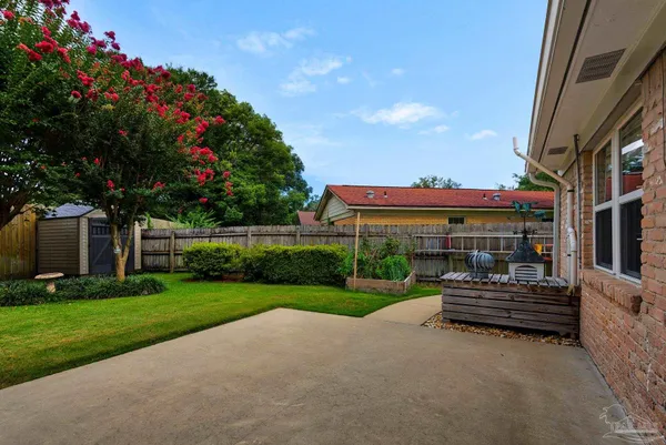 a view of a house with backyard and sitting area