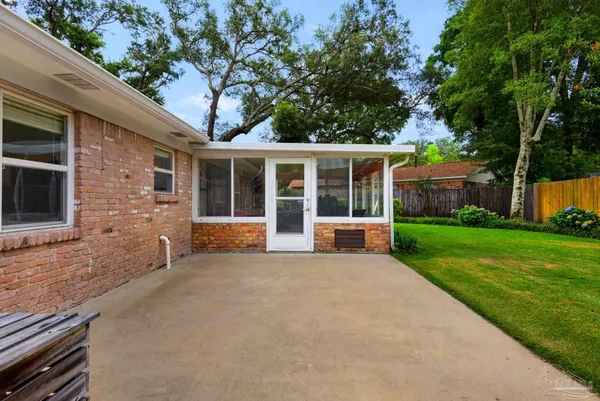 a view of a house with backyard and a garden