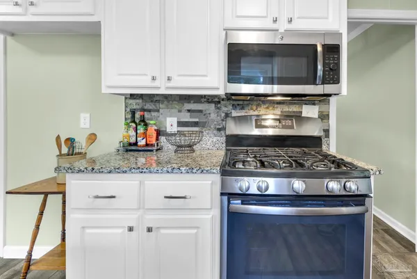 a stove top oven sitting inside of a kitchen
