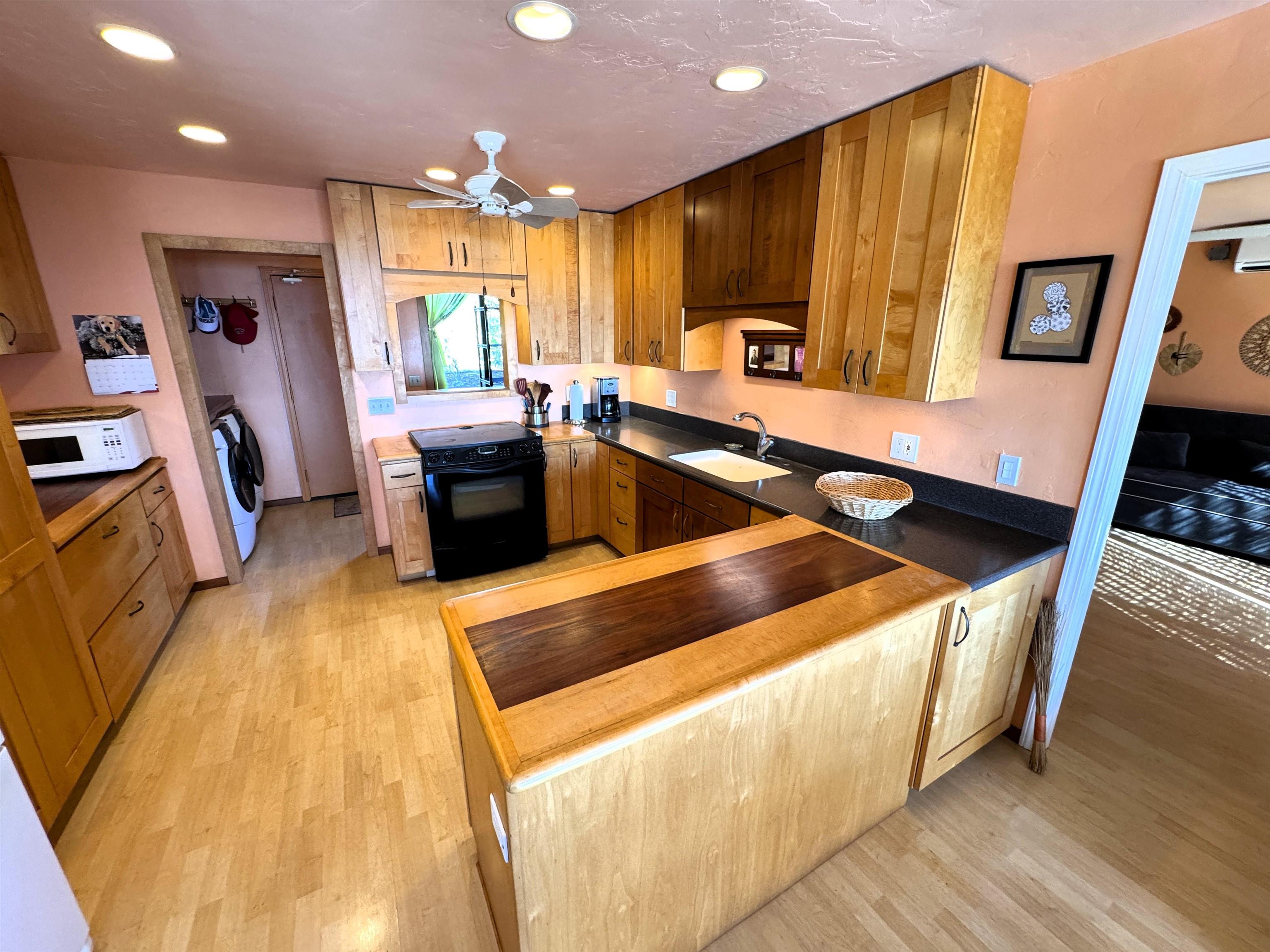 380 Ulua Road, Unit LOT 171 Kaunakakai, HI 96748 - Photo 12 of 44 a kitchen with stainless steel appliances granite countertop a stove a sink dishwasher and a refrigerator with wooden floor