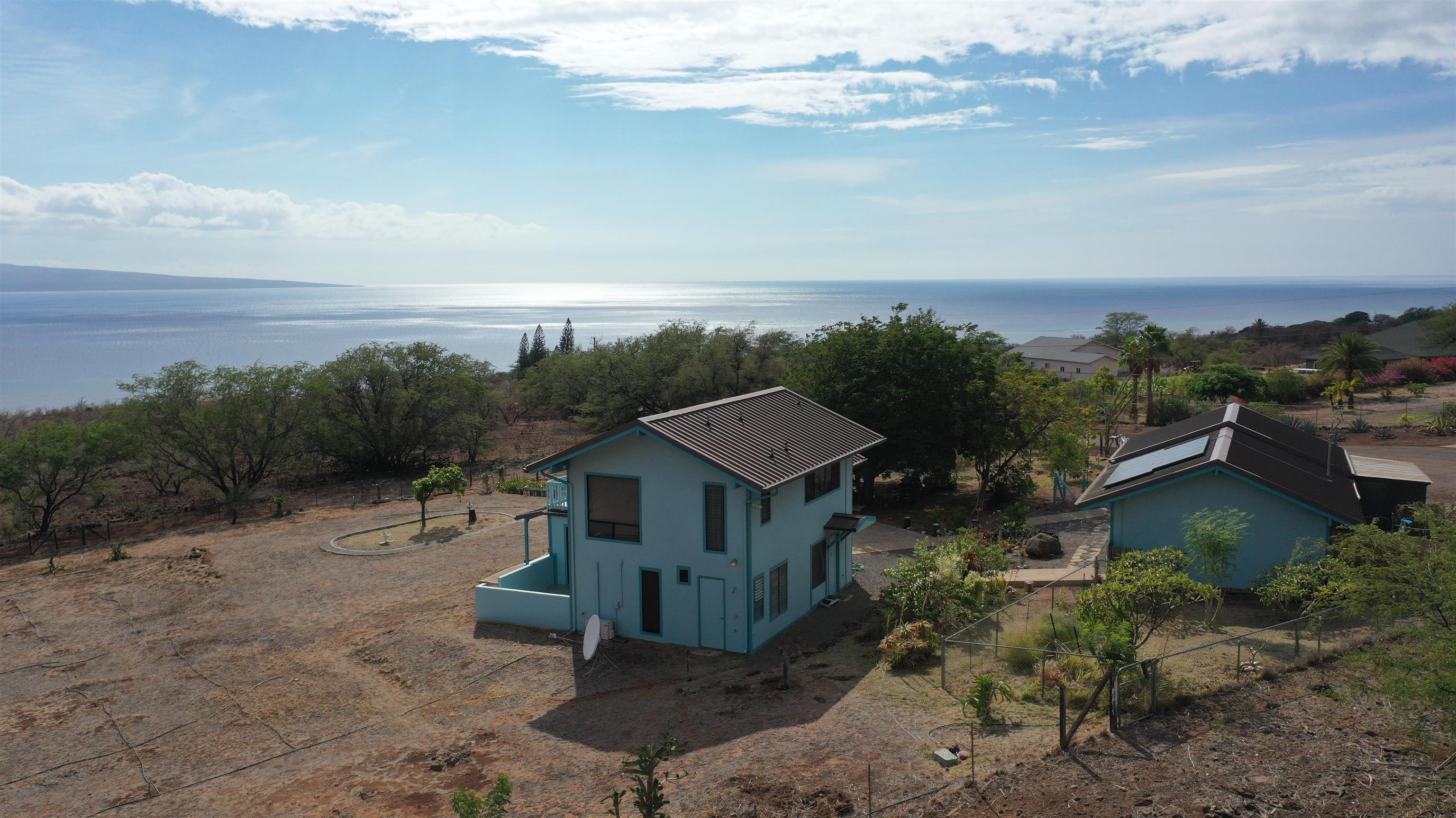 380 Ulua Road, Unit LOT 171 Kaunakakai, HI 96748 - Photo 2 of 44 a view of a house with a yard and a lot of trees