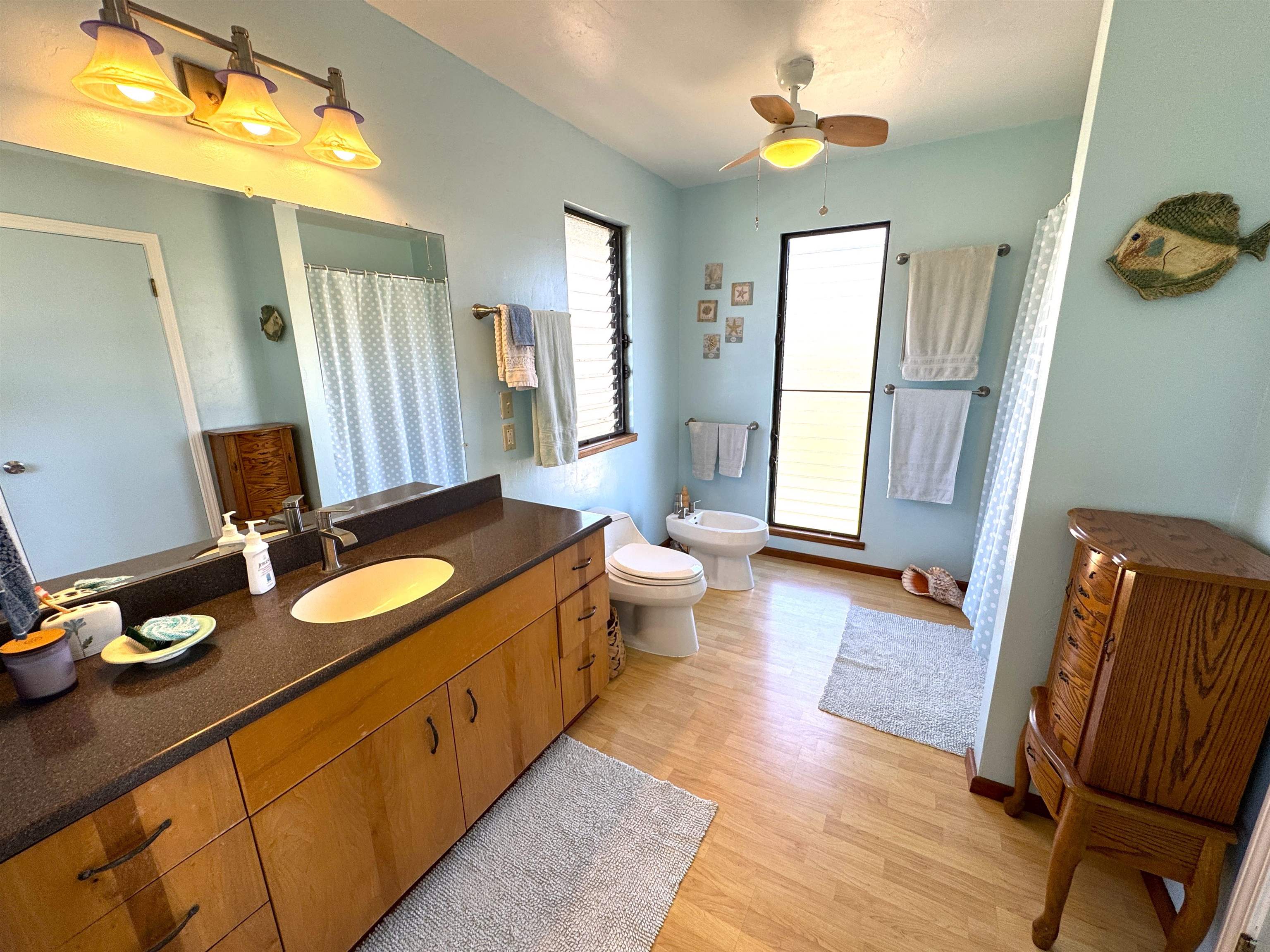 380 Ulua Road, Unit LOT 171 Kaunakakai, HI 96748 - Photo 24 of 44 a bathroom with a granite countertop sink a toilet a mirror and shower