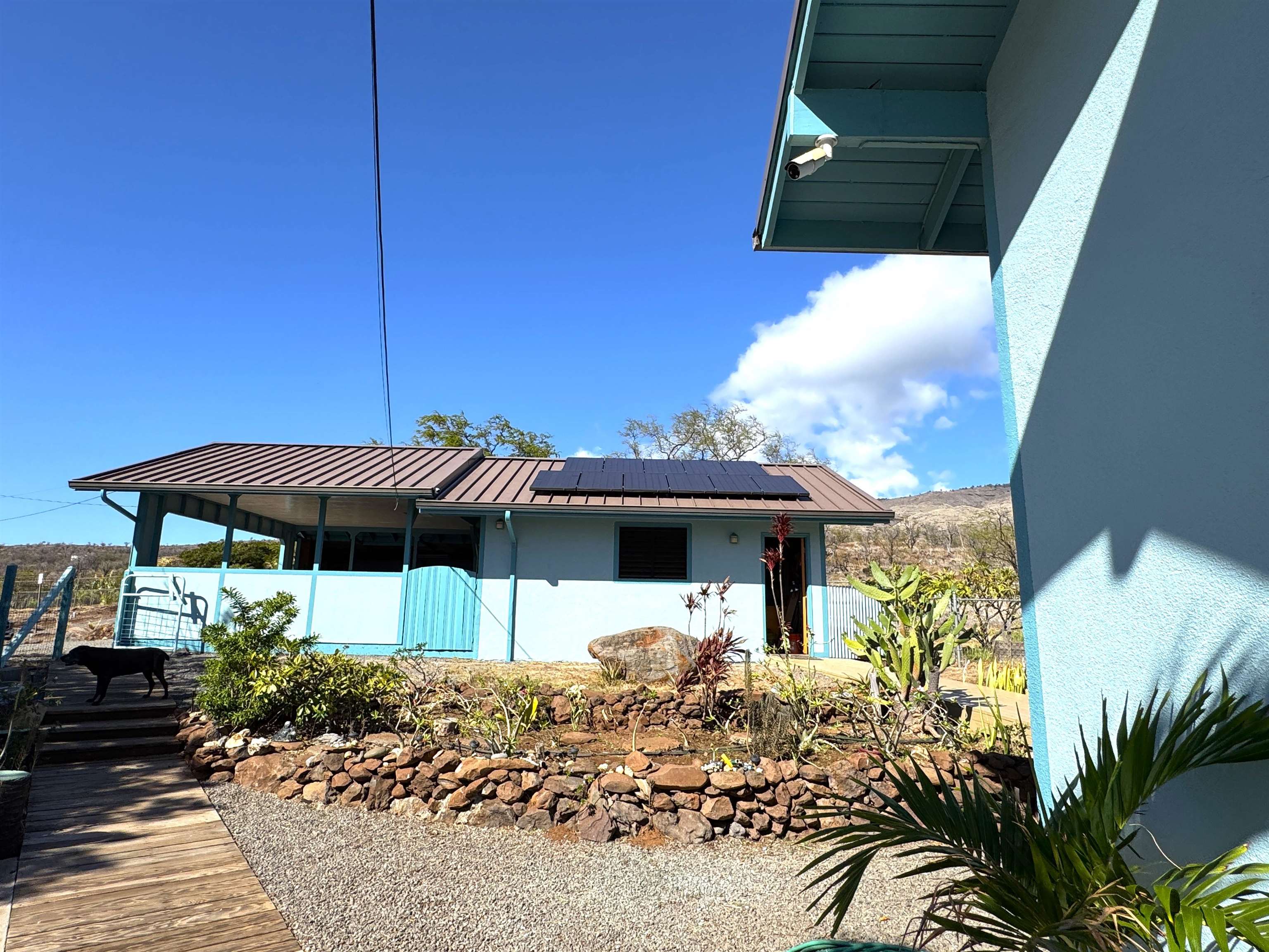 380 Ulua Road, Unit LOT 171 Kaunakakai, HI 96748 - Photo 29 of 44 a view of a patio with table and chairs under an umbrella with potted plants
