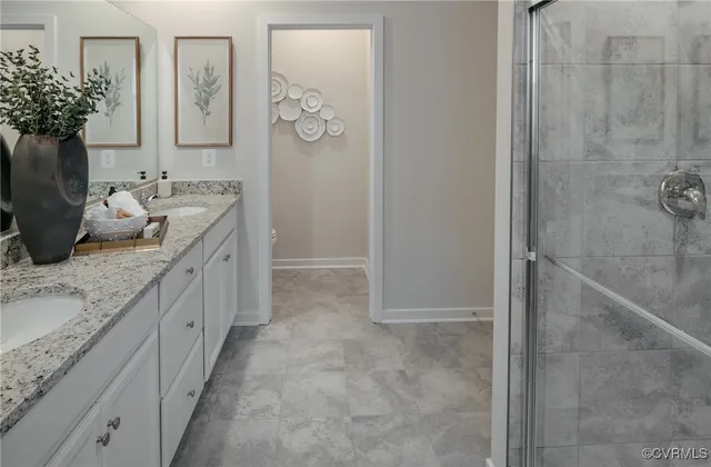 a bathroom with a granite countertop sink a mirror and a shower