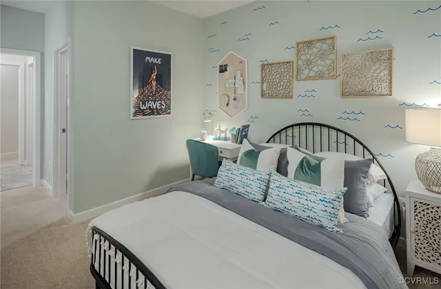 a bed sitting in a bedroom next to a window