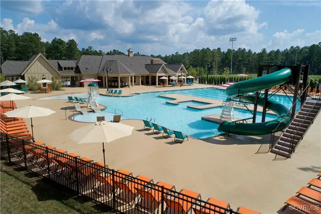 an aerial view of a house with swimming pool and furniture