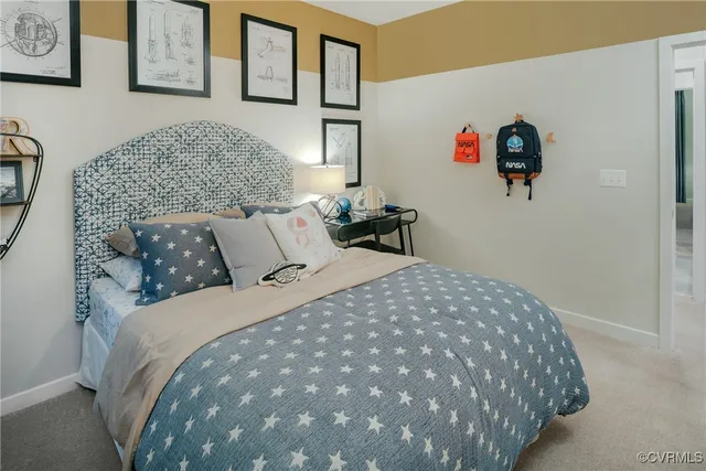 a bedroom with a bed and painting on the wall