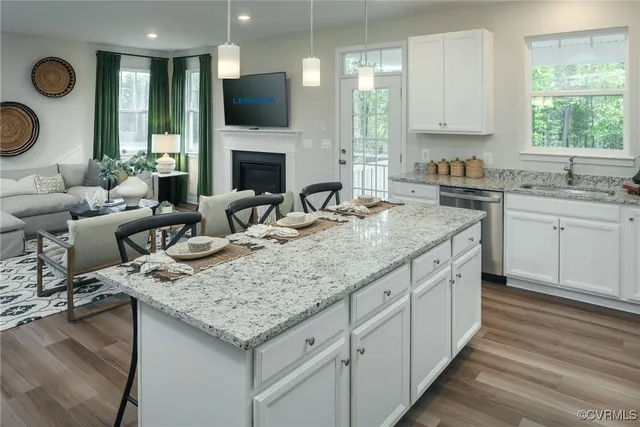 a kitchen with granite countertop lots of counter top space and living room