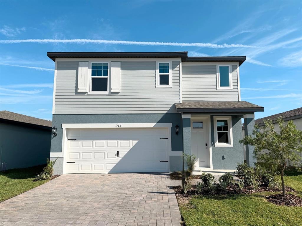 1786 Brekey Way Zephyrhills, FL 33541 - Photo 1 of 1 a front view of a house with garden