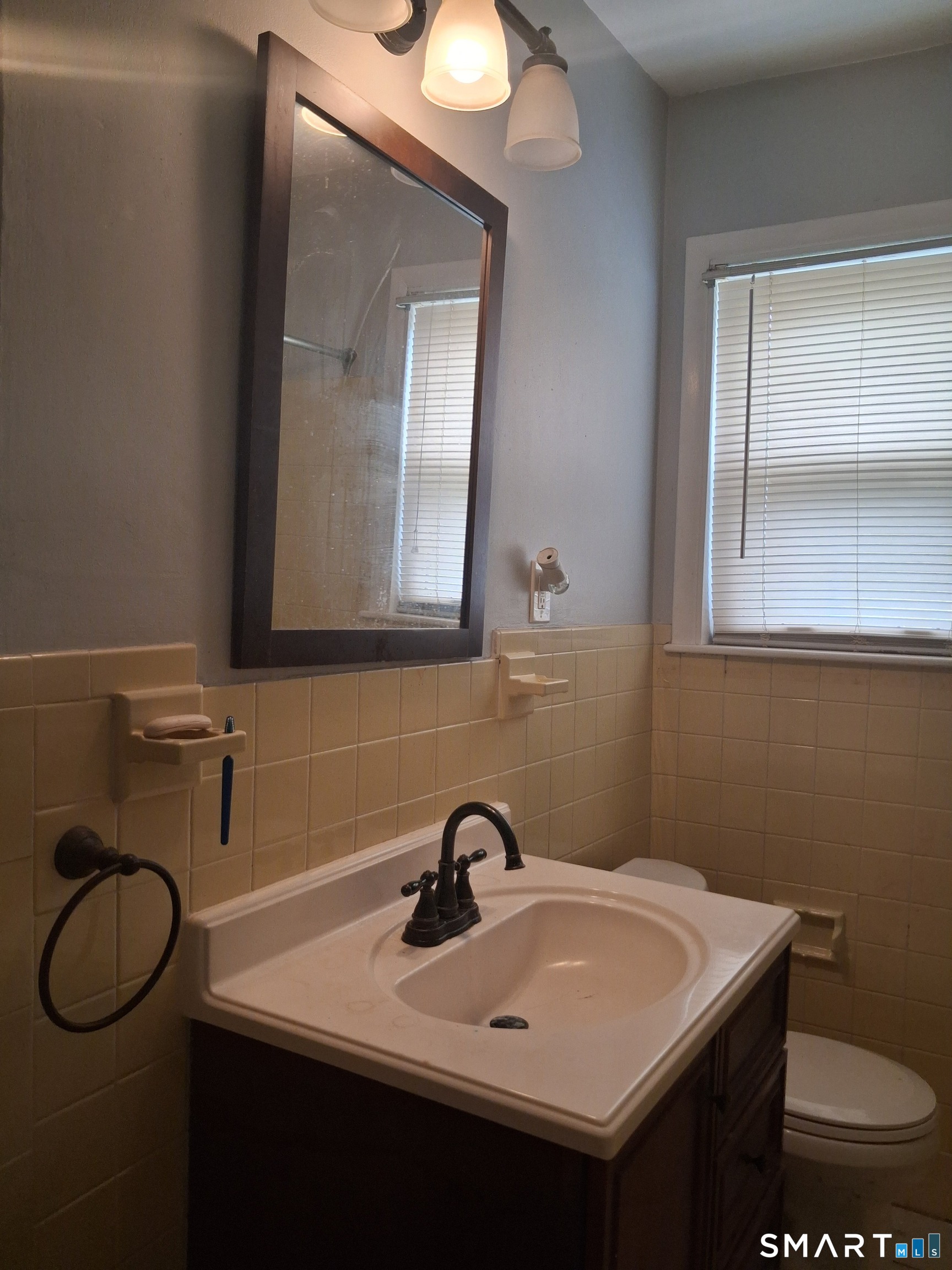 26 4th Street Hamden, CT 06514 - Photo 37 of 40 a bathroom with a toilet sink and mirror