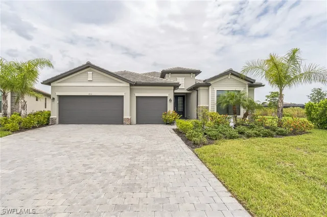 a front view of a house with a garden and trees
