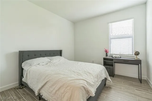 a bed sitting in a bedroom next to a window