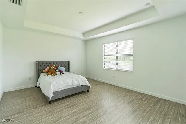 a bedroom with a bed and window