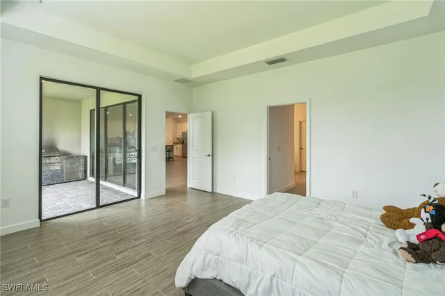 a bedroom with a bed and glass door