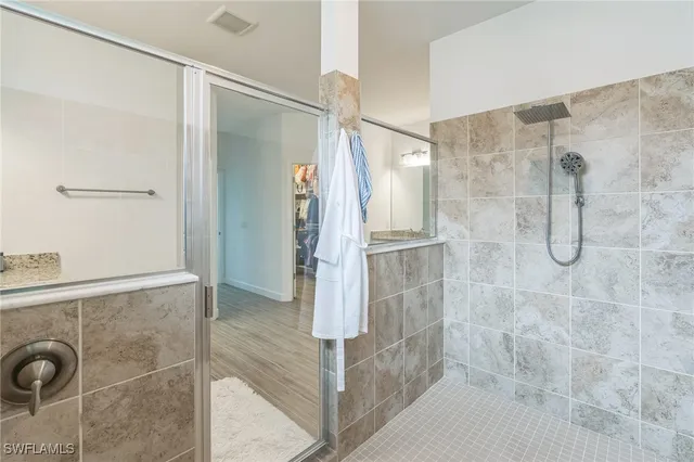 a bathroom with a shower and a glass door