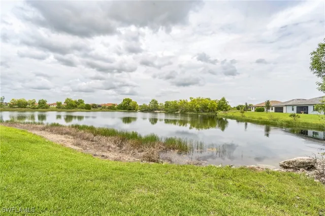 a view of a lake with houses in the back