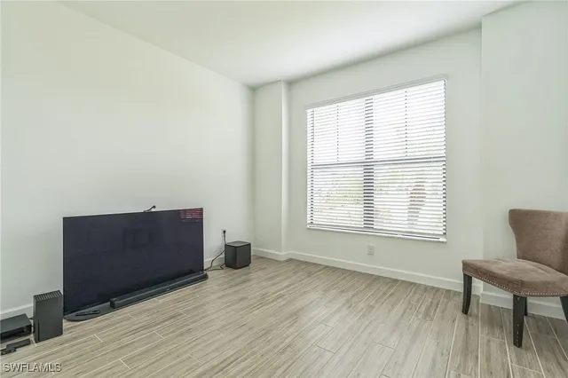 a view of room with window and wooden floor