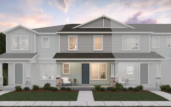 a front view of a house with a yard and outdoor seating