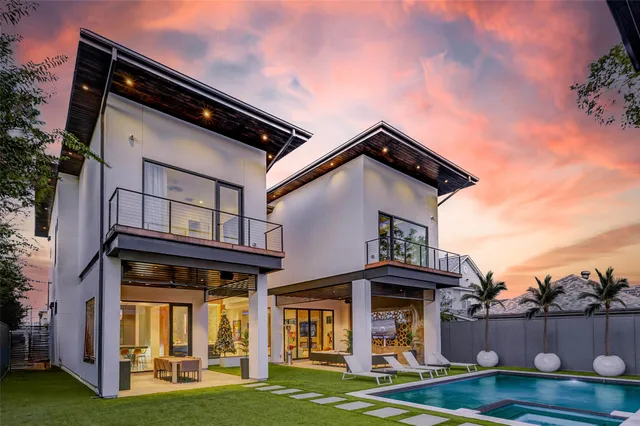 a view of a patio with couches table and chairs with garden view